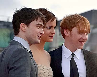 Daniel Radcliffe, Emma Watson, and Rupert Grint at a premiere